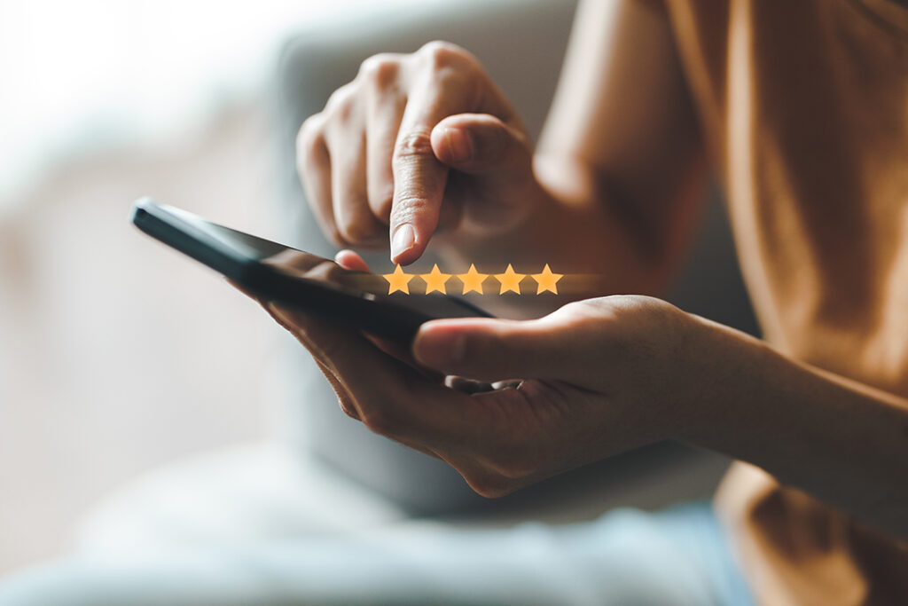 Close up of woman customer giving a five star rating on smartpho