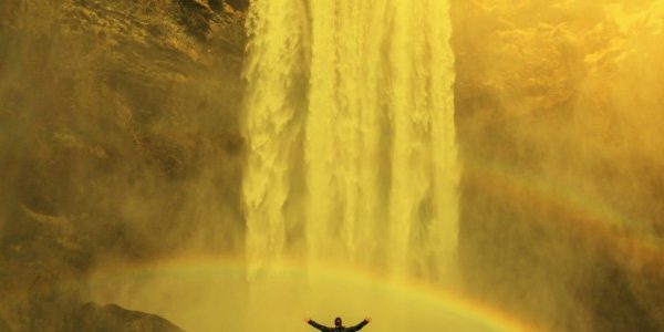 image of a man in a rainbow below a waterfall showing six sources of inspiration for charity digital teams